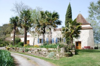In a charming country setting, at calm and with lovely views, magnificent character property comprising a stone main house, guest house with attached cinema/disco/playroom, pigeonnier, guest house with attached barn, a large detached traditional stone bar